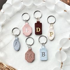 four different keychains with the letter d on them