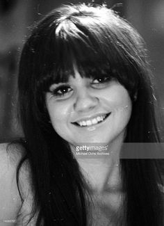 a black and white photo of a woman smiling