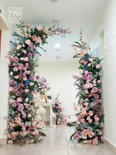 an archway decorated with pink and blue flowers