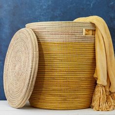 Small / Medium size storage basket with flat lid in yellow and beige colors. Measures approx. 15" diameter, and 17" height. For storing toys or 4 throw blankets. Woven from grass and recycled plastic ribbons using traditional coil weaving technique. Handmade by Wolof tribe women in Senegal, Africa. --------------------- The Wolof people in Senegal are known for weaving colorful baskets from locally harvested cattail stalks and strips of plastic. They weave handmade baskets of different sizes and White Storage Baskets, Storage Baskets With Lids, Colorful Baskets, Grass Basket, Large Storage Baskets, Women Crafts, Yellow Beige, Handmade Baskets, Weaving Process