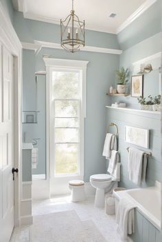 a bathroom with blue walls and white fixtures