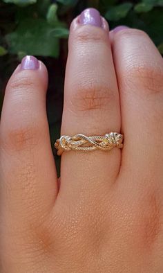 a woman's hand with a gold ring on it