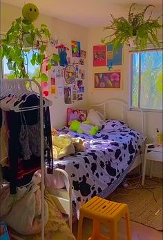 a bed room with a neatly made bed and lots of plants