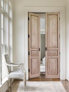 an open wooden door in a white room