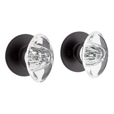 two black door knobs with clear glass on the front and back sides are shown