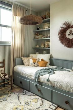 a bedroom with a twin bed and shelves on the wall next to it is decorated in neutral colors