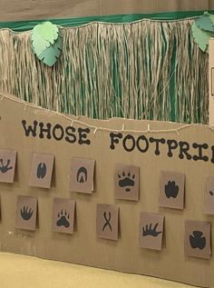 a cardboard sign that says whose footprints are on it