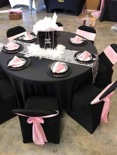 a black table with pink and white decorations