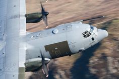 an air force jet flying through the sky with its landing gear down and it's engine out