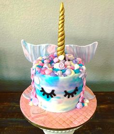 a birthday cake decorated with an unicorn horn