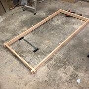 an unfinished bed frame sitting on the ground