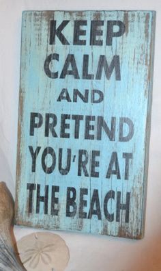 a sign that says keep calm and pretend you're at the beach