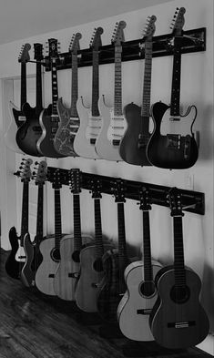 several guitars are hanging on the wall