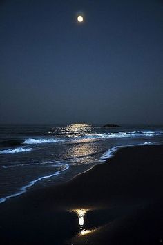 the moon is shining brightly over the ocean