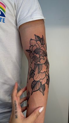 a person with a flower tattoo on their arm