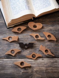 several wooden bats are placed in front of an open book on a table with the pages cut out