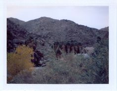 an old photo of mountains in the desert