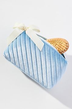 Softly quilted with a playful ribbon on the side, this cosmetic bag is as stylish as it is practical. | Quilted Velvet Cosmetic Bag by Anthropologie in Blue, Polyester/Spandex Cos Bags, Storing Makeup, Cute Makeup Bags, Quilted Velvet, Fancy Gifts, Cute Makeup, Beauty Essentials, Blue Bags, Makeup Accessories