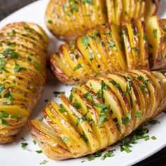 baked potatoes on a white plate with parsley