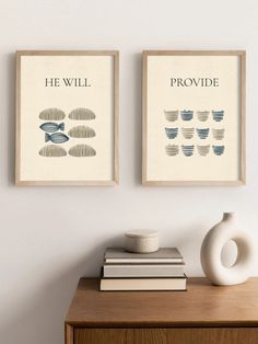 two framed art prints on the wall above a dresser with books, vase and plant