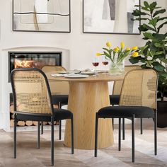 a dining room table with four chairs and a fire place in the fireplace behind it