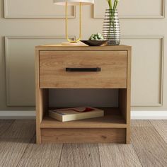 a bedside table with a lamp on top