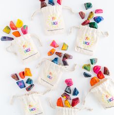 small bags filled with colorful candy on top of a white table