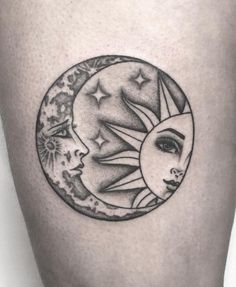 a woman's thigh with a sun and moon tattoo on it