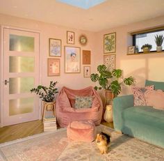 a living room filled with lots of furniture and plants on top of a rug in front of a doorway