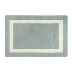 a blue and white rug with a border on the bottom, in front of a white background