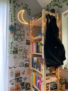 a book shelf filled with lots of books next to a wall covered in magnets