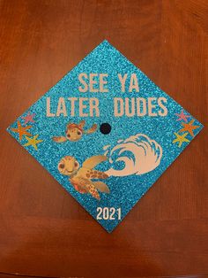 a blue graduation cap with the words see ya later dudes written in gold on it