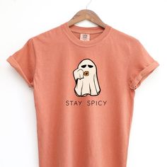 Stay Spicy - This super comfy graphic Comfort Colors T-shirt for women features a cute ghost sipping a spiced seasonal beverage. Colors Available: Yam and Pepper Sizes: S - 4XL D E T A I L S: .:: Brand - Comfort Colors from Gildan .:: Unisex Adult Sizing .:: Pre-shrunk 100% ring spun cotton .:: DTG (Direct-to-Garment) printing .:: Soft washed garment dyed fabric with twill label .:: Double-needle stitching on neck, sleeves and bottom hem .:: Shoulder-to-shoulder taping; set-in sleeves Halloween Cute Ghost, Pumpkin Spice Shirt, Fall Shirts Women, Pilot Gifts, Halloween Cute, Ghost Shirt, Fall Shirt, Cute Ghost, Halloween Women