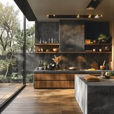 a modern kitchen with wooden floors and black counter tops is seen from the outside in this image