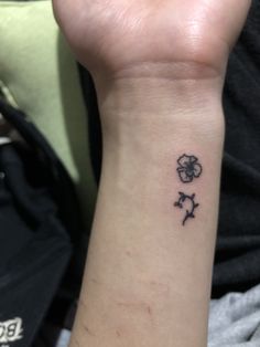 a person with a small tattoo on their wrist