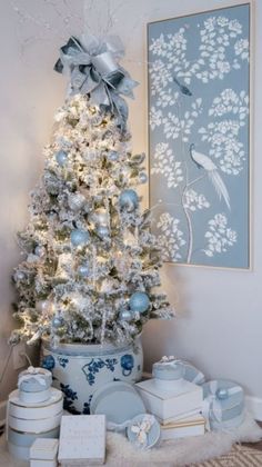 a white christmas tree with blue and silver ornaments