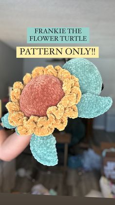 a hand holding up a crocheted flower with the words franklin the flower turtle pattern only