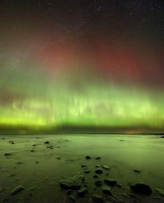 an aurora bore is seen over the ocean