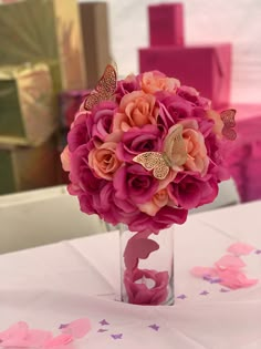 a vase filled with pink flowers on top of a table