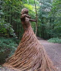 a sculpture made out of sticks in the woods