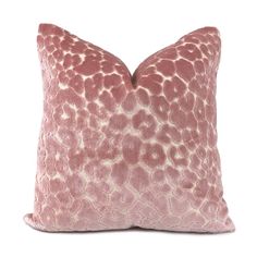 a pink and white pillow with an animal print pattern on the front, sitting on a white background