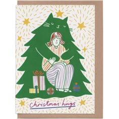 a christmas card with a woman sitting in front of a tree