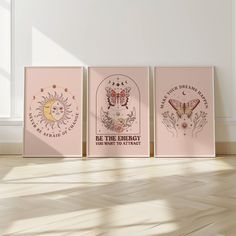 three pink posters on the wall in an empty room with wood flooring and white walls