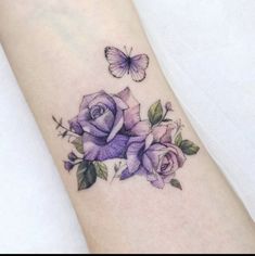 a purple rose and butterfly tattoo on the wrist