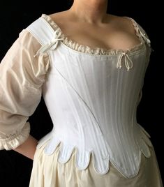 "Exemplify seventeenth century elegance in this shapely corset. This corset is rigidly boned with closely spaced 1/4\" steel bones and is cut to enhance and lift the bust, and shape the waist. The waist tabs, cut in one with the corset, curve over the hips. The shoulder straps form the high back and off the shoulder neckline, a hallmark of this period. This style is also available without tabs. Features include: Ø Side seam alteration point for an adjustable fit Ø Center back lacing Ø Shoulder s 18th Century Dress, Dress Tutorials, Period Outfit, Historical Dresses, Fashion Plates, Historical Clothing, Historical Fashion, Fashion Fabric, Corsets