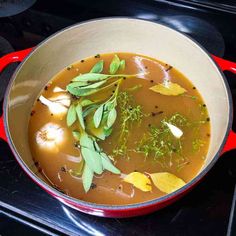 a pot filled with soup sitting on top of a stove