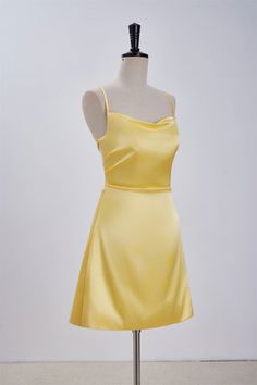 Expertly crafted from satin fabric, this stunning A-line dress boasts a striking cowl neck and delicate spaghetti straps. The back features a lace-up design, while the above knee length adds a touch of elegance to the overall silhouette. Available in a vibrant yellow hue, this dress is sure to make a statement. Item #NP1113 Material: Satin Color: Yellow Silhouette: A-line Embellishment: Cowl neck Neck: Spaghetti straps Back: Lace-up Length: Above knee length Fully lined: Yes Built-in bra: Yes True to size. Made in China. Dresses are usually packed inside out for protection. Hand wash Yellow Hoco Dress, Yellow Satin, A Line Shorts, Grad Dresses, Satin Color, Short Prom, Satin Mini Dress, Hoco Dresses, Above Knee