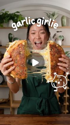 a woman holding two pieces of pizza in front of her face with the caption garlic grille