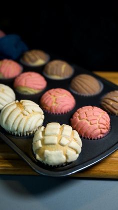 there are many cupcakes on the tray ready to be eaten