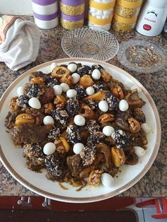 a white plate topped with lots of food on top of a counter next to bottles